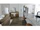 Open kitchen and living area featuring granite counters, white cabinets, and modern appliances at 4811 Lake Park Ter, Acworth, GA 30101