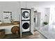 Concealed laundry area featuring modern, stacked washer and dryer at 4811 Lake Park Ter, Acworth, GA 30101