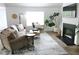 Bright living room featuring a comfortable sofa, fireplace, and stylish decor at 4811 Lake Park Ter, Acworth, GA 30101