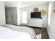 Bright main bedroom with white furniture, built-in storage, and a large window at 4811 Lake Park Ter, Acworth, GA 30101