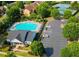 Aerial view of community pool, clubhouse, tennis courts and parking at 634 Friars Head Dr, Suwanee, GA 30024