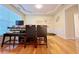 Bright dining room with hardwood floors, modern decor, and adjacent to a large window at 634 Friars Head Dr, Suwanee, GA 30024