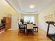 Bright dining room features modern lighting, wainscoting, and seating at 634 Friars Head Dr, Suwanee, GA 30024