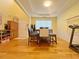 Inviting dining room with hardwood floors, a tray ceiling, and large window at 634 Friars Head Dr, Suwanee, GA 30024