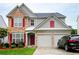 Charming two-story home with stone accents, red shutters, and attached two-car garage at 634 Friars Head Dr, Suwanee, GA 30024