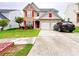Beautiful home featuring manicured landscaping and a driveway leading to a two-car garage at 634 Friars Head Dr, Suwanee, GA 30024
