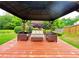 Relaxing gazebo interior with ample seating and swing for entertaining guests at 634 Friars Head Dr, Suwanee, GA 30024