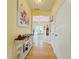 Hallway to living area featuring an antique table and wood floors at 634 Friars Head Dr, Suwanee, GA 30024
