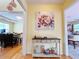 Hallway featuring wall art, modern table and decor with wood floors at 634 Friars Head Dr, Suwanee, GA 30024