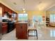 Open kitchen featuring dark cabinets, tile backsplash, and stainless steel appliances at 634 Friars Head Dr, Suwanee, GA 30024