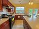 Well-lit kitchen boasts stainless steel appliances, ample counter space, and wooden cabinetry at 634 Friars Head Dr, Suwanee, GA 30024