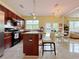 Open kitchen featuring modern appliances and breakfast bar with chandelier at 634 Friars Head Dr, Suwanee, GA 30024