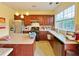 Well-lit kitchen with wooden cabinets, a large island, and stainless steel appliances at 634 Friars Head Dr, Suwanee, GA 30024
