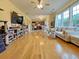 Spacious living room with hardwood floors, large windows, and an open view to the kitchen at 634 Friars Head Dr, Suwanee, GA 30024