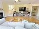 Comfortable living room featuring a fireplace, staircase, and view into another room at 634 Friars Head Dr, Suwanee, GA 30024