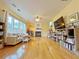 Bright living room featuring a fireplace, hardwood floors, large windows and contemporary furnishings at 634 Friars Head Dr, Suwanee, GA 30024