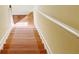 Wooden staircase with white risers and handrail leads to the upper level at 634 Friars Head Dr, Suwanee, GA 30024