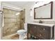 Updated bathroom with modern vanity, mirror, toilet, and tile shower with glass doors at 906 Country Park Se Dr, Smyrna, GA 30080