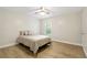 Well-lit bedroom showcasing a queen bed, neutral walls, and ample natural light from the window at 906 Country Park Se Dr, Smyrna, GA 30080