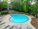 Relaxing community pool surrounded by lush greenery and comfortable lounge chairs at 906 Country Park Se Dr, Smyrna, GA 30080