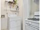 Utility area with white appliances and shelving at 906 Country Park Se Dr, Smyrna, GA 30080