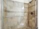 Close-up of tiled walk-in shower with bronze fixtures and glass doors at 906 Country Park Se Dr, Smyrna, GA 30080