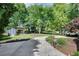 Expansive backyard with a lush lawn, mature trees, storage shed, and well-maintained landscaping at 243 Woodview Ln, Smyrna, GA 30082