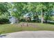 Large grassy backyard featuring a storage shed and a fenced-in garden area at 243 Woodview Ln, Smyrna, GA 30082