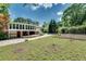 Lush backyard featuring mature trees, a storage shed, and a well-kept lawn at 243 Woodview Ln, Smyrna, GA 30082