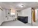 Unfinished basement with gray painted floor, concrete walls, cabinetry, and small window at 243 Woodview Ln, Smyrna, GA 30082