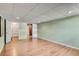 Finished basement with hardwood floors, drop ceiling, recessed lighting, closet, and green walls at 243 Woodview Ln, Smyrna, GA 30082