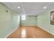 Finished basement with hardwood floors, drop ceiling, recessed lighting, and green painted walls at 243 Woodview Ln, Smyrna, GA 30082