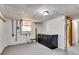 Basement area with dark cabinets, granite countertop, window, and view to the bathroom at 243 Woodview Ln, Smyrna, GA 30082