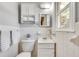 Tiled bathroom features a white vanity, toilet, mirror, and storage cabinet with shelves at 243 Woodview Ln, Smyrna, GA 30082