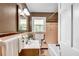 Traditional bathroom featuring a wood vanity, neutral-toned tile, and bright natural light from the window at 243 Woodview Ln, Smyrna, GA 30082