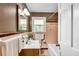 Bathroom with brown and peach tiling, and white sink, toilet, and tub at 243 Woodview Ln, Smyrna, GA 30082