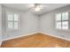 Light-filled bedroom with hardwood floors and large windows with white shutters at 243 Woodview Ln, Smyrna, GA 30082