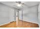 Bedroom features hardwood floors, neutral walls, ceiling fan, white door and trim, and a closet at 243 Woodview Ln, Smyrna, GA 30082