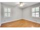 Bright bedroom with hardwood floors, two windows with shutters, and a ceiling fan at 243 Woodview Ln, Smyrna, GA 30082