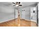 Spacious bedroom featuring hardwood floors, fresh paint, and connecting access to the bathroom at 243 Woodview Ln, Smyrna, GA 30082