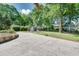 Long concrete driveway leading to a well-maintained backyard with a storage shed and garden at 243 Woodview Ln, Smyrna, GA 30082