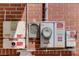 Close-up of solar panel electrical components and meter system installed on the exterior brick wall of the home at 243 Woodview Ln, Smyrna, GA 30082