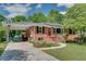 Charming brick home with a covered carport and beautifully landscaped front yard at 243 Woodview Ln, Smyrna, GA 30082