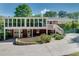Rear exterior displaying a spacious sunroom, a two-car garage, and a well-manicured yard at 243 Woodview Ln, Smyrna, GA 30082