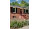 Charming brick home with a decorative front door and iron railing steps at 243 Woodview Ln, Smyrna, GA 30082