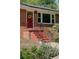 Inviting front entrance with a red door, traditional brick facade, and well-maintained landscaping at 243 Woodview Ln, Smyrna, GA 30082