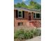 Charming brick home with a welcoming red front door and well-maintained landscaping, offering curb appeal at 243 Woodview Ln, Smyrna, GA 30082