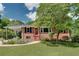 Cozy brick home with a covered carport, neat landscaping, and a welcoming front entrance at 243 Woodview Ln, Smyrna, GA 30082