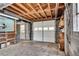 Unfinished garage featuring block walls, exposed ceiling beams, and a white garage door at 243 Woodview Ln, Smyrna, GA 30082