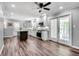 Bright kitchen with white cabinets, stainless appliances, and an island, leading to an enclosed patio at 243 Woodview Ln, Smyrna, GA 30082